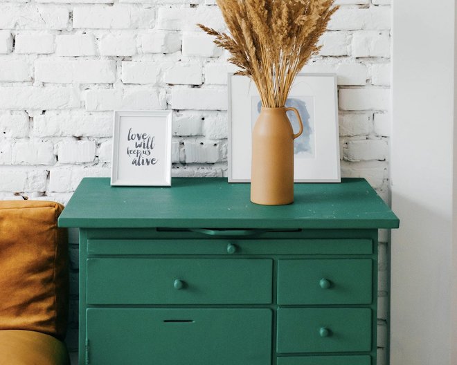 A green drawers in a light room